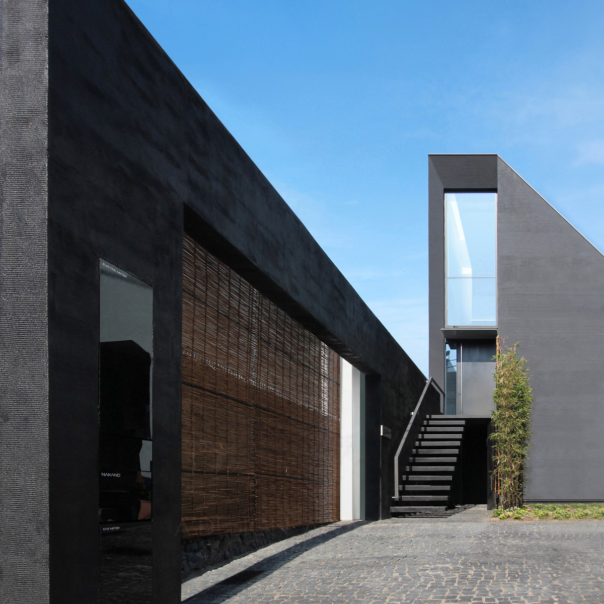 Black Monolithic Wall Residential House by Nobuaki Miyashita