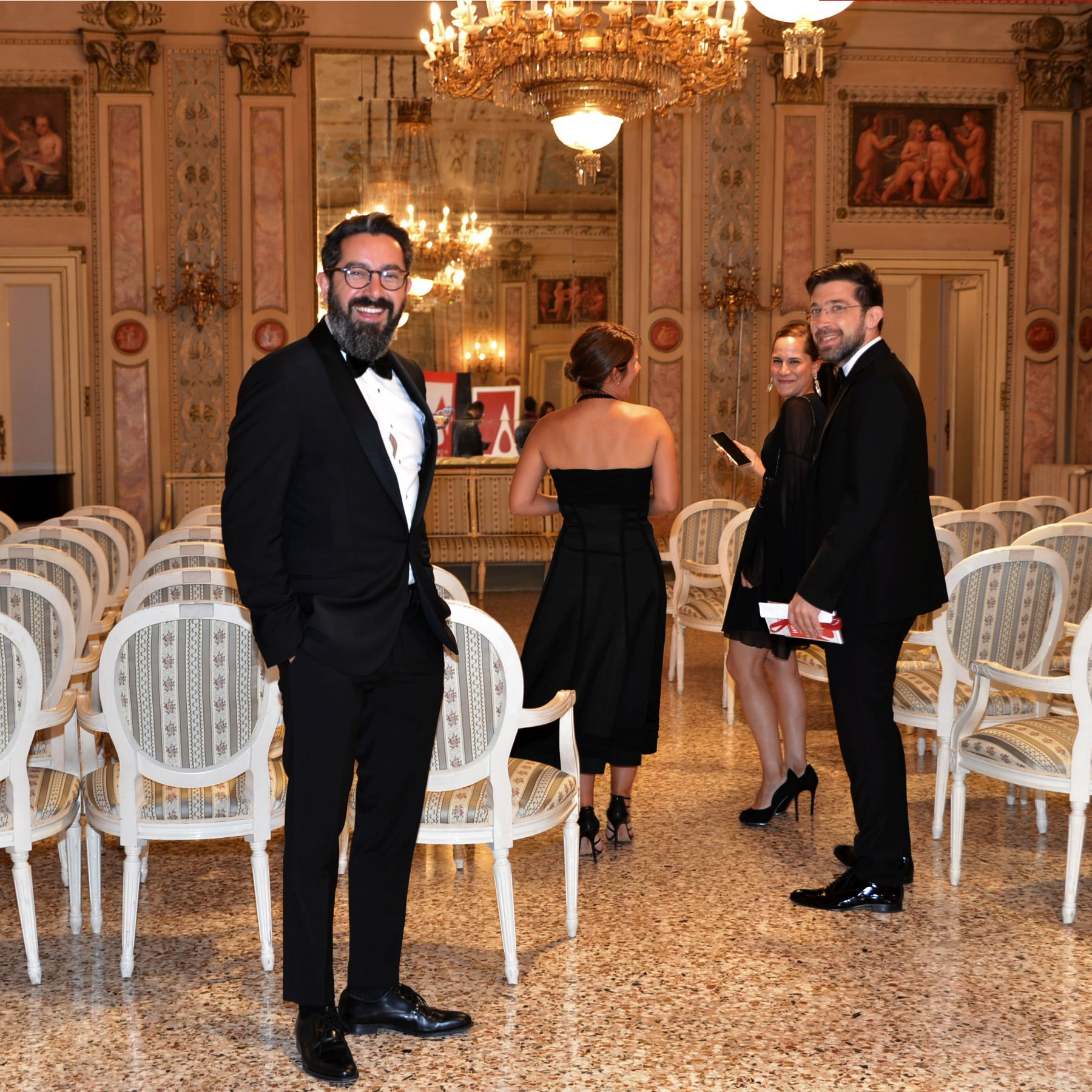 Well-dressed designers smiling at gala-night