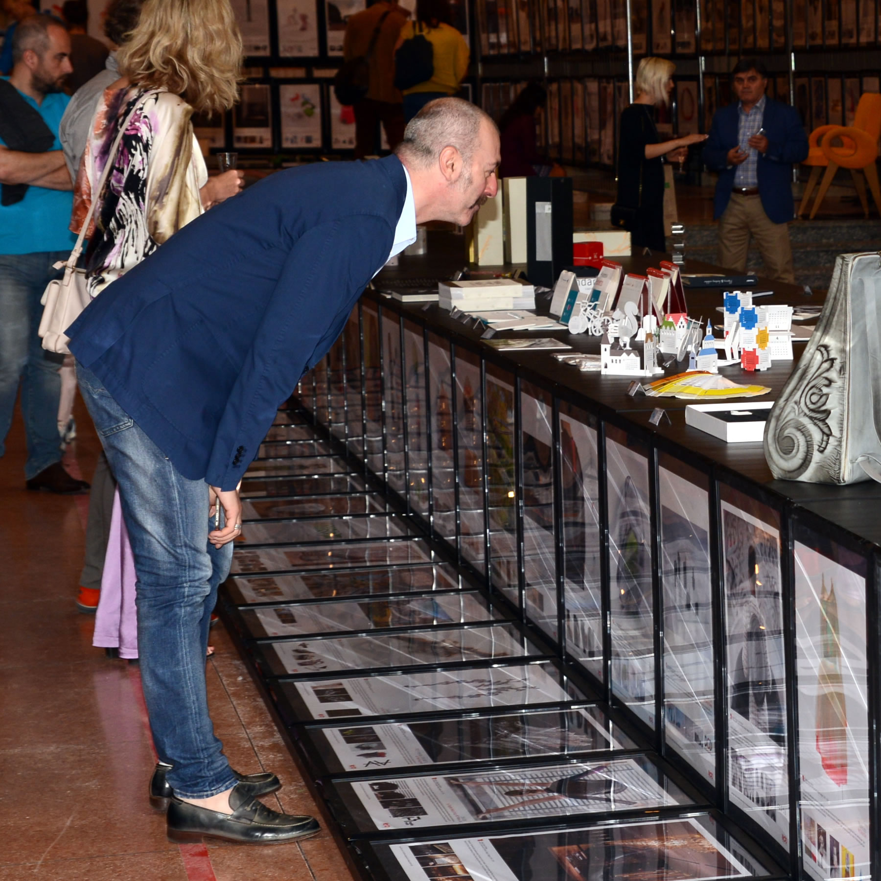 Designers checking artwork and designs in design exhibition