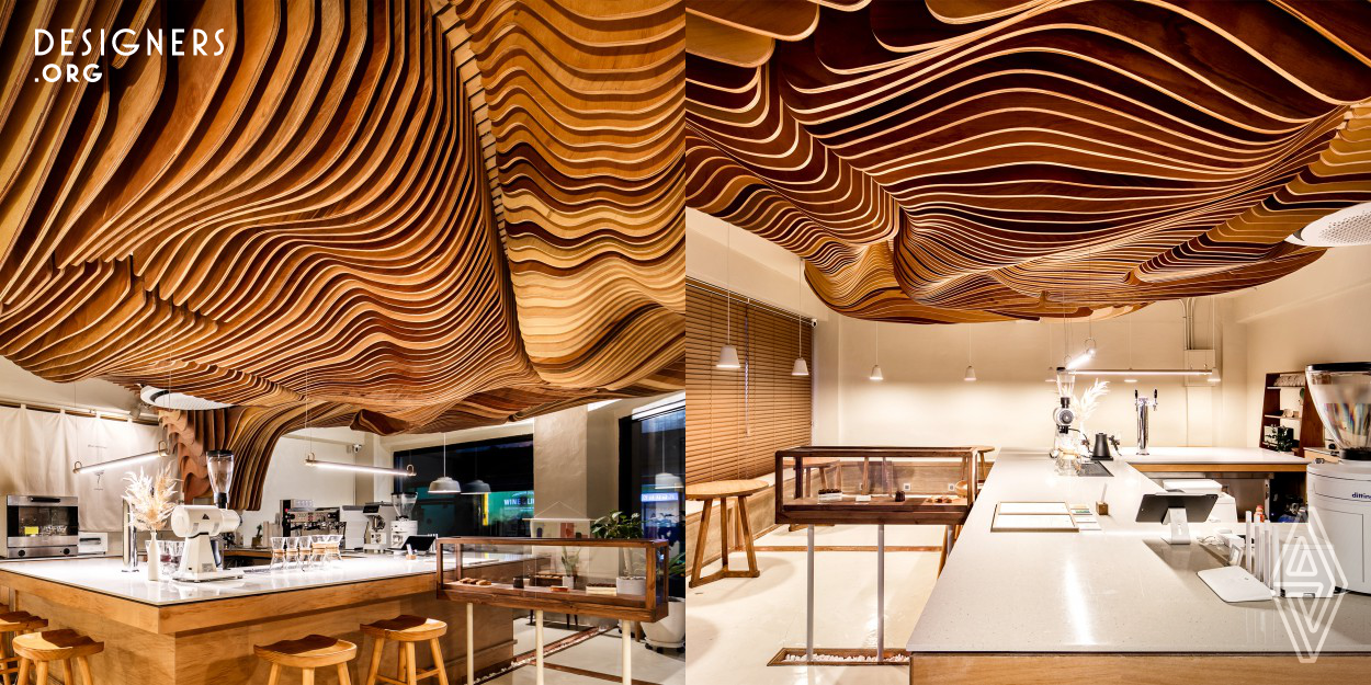 This small warm wooden feel cafe located on the corner of crossroad within a quiet neighborhood. The centralized open-preparation zone makes a clean and extensive experience of barista's performance to visitors everywhere that bar seat or table seat in a cafe. The ceiling object called "Shading tree" starts from the backside of the preparation zone, and it covers the customer zone to makes the entire atmosphere of this cafe. It gives an unusual spatial effect to visitors and also become a medium for people who want to be lost in thought with flavorous coffee.