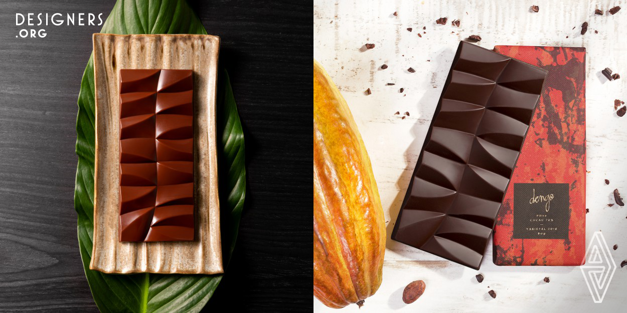 The design is inspired by the origin of Dengo's cacao – the heart of the Atlantic Forest in Bahia, Brazil. The cacao is harvested in cabruca, a traditional agroforestry and forest-positive system. In an effort to inspire, create brand recognition and convey the brand's message to the consumer, the designers turned the chocolate bar into a sculpture that represents some of the surrounding elements, such as dry leaves on the ground, foliage of the tall trees that provide beautiful play of light and shadow, and a variety of seeds.