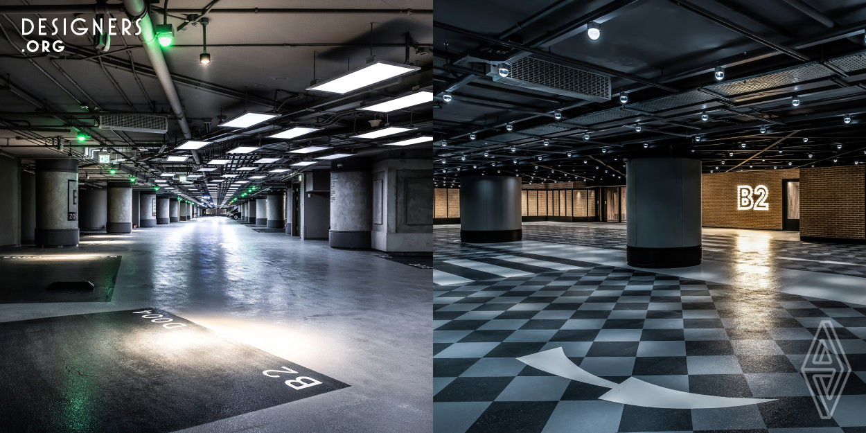 Inside the 4-storey car park, a dynamic atmosphere arises from the interplay of vibrantly coloured walls and floors, innovative traffic signs and striking contemporary graffiti. Connected to the entrance to the shopping mall is the B2 level of the car park, which is fitted with grids of light bulbs, metallic ceilings, red brick walls and checkered floors in the style of a classic theatre entrance.