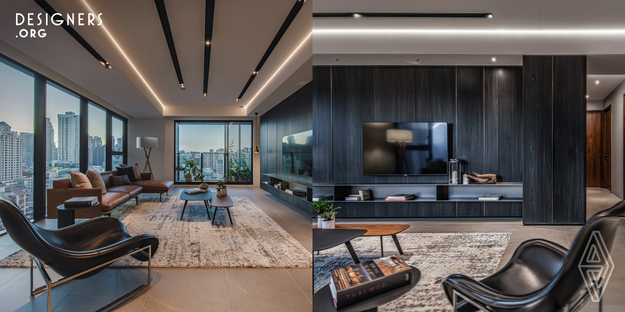 The residential project locates in Taichung, Taiwan. The designer creates a work embellished with contemporary spirit through the use of materials and construction methods. While the ink-black color tone extends to the wood wall and the whole space, a poetic and artistic panoramic view of the space is presented. The designer decreases the lightness of the space; therefore, a dark-color tone dominates the space visually. With subtle decoration, the design brings about a sense of elegance mixing with slight luxury.