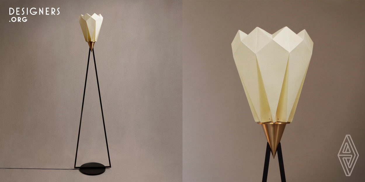 Adamas lamp tries to combine the elegance of the Italian design tradition and the beauty of the Japanese origami art, with a calibrated match of different materials. The paper lampshade, realized by hand through origami technique, provides a warm and soft light. The iron, chosen for its physical characteristics, allows a slender structure that wants to enhance the lightness of the lampshade. The connection between these two elements shape is a brass cone, which serves as lamp holder. 