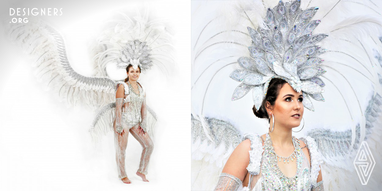 This design is reminiscent of wings. A play on the flights of people coming to see the beauty of the Islands. The focus on the white costume with blue reflective accents reflects the white sand and blue waters. This design is to highlight the importance of the Cayman Islands marine environment and the need to preserve it so local people and visitors can enjoy it for years to come. But more importantly, as a small island nation, this design represents a plea for the world to do its part in taking care of the environment, especially the oceans. 
