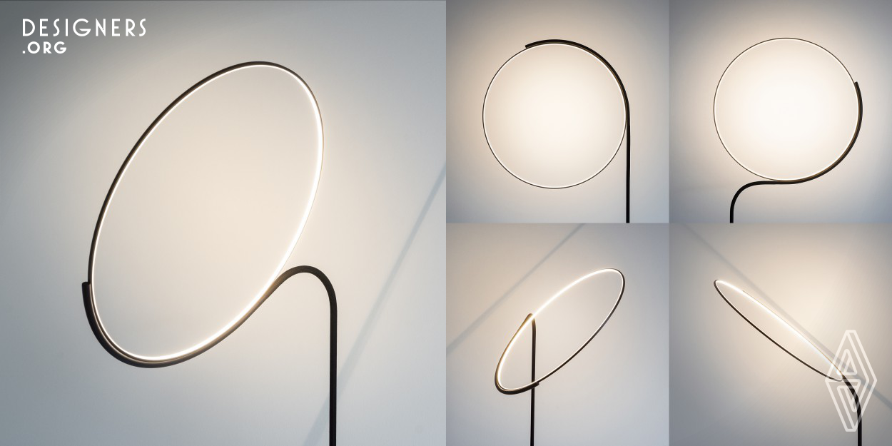 Cling is a floor lamp by Robert Dabi. Emerging from the floor plate, the pole seamlessly wraps around a spotless LED ring made of a slim aluminium profile in a diameter of 55 cm. Within the area between pole and the frame holding the light ring, a flexible section is incorporated. This makes it possible to freely move or tilt the ring and thereby adapt the appearance of the lamp to its' surrounding. Robert constructed the lamp with stability in mind – heavy lower steel parts and top aluminium parts sum up to only 2,5 kg of weight. 