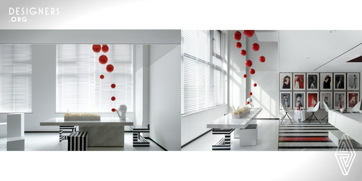 It is an interior design case for a two-story photographer's studio with an indoor area of 82 square meters. The designer satisfies the client for all her requirements including shooting, reception, work, and video broadcast through a reasonable space layout. Meanwhile, the designer uses red, black, and white to construct a feeling of confrontation in space and expresses a strong visual impact and scene memory.