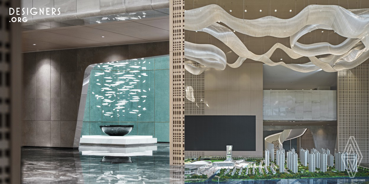 The base color of the marble floor is dark grey, with white veins on it, just like ripples on the water's surface. Meanwhile vertical grilles make it a unique space. The shimmering lights on the reception desk are like the lights of distant fishing boats seen at night bobbing in the wind. The overall space is decorated in an orderly fashion. The restrained colors and the rational textures stretching upwards are unified in their light warm tones and as a result the soothing atmosphere is comfortable and reserved, helping people to relax and feel at ease.