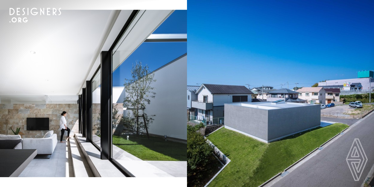 The "House in Shinjo" has no windows outside. That is due to the site's unique condition, which is along the national highway bypass. The house has an inner courtyard like a hole in a square block as a device to let in light and wind while closing to the outside. The building is a wooden structure. In spite of the structural constraints, the designers focused on creating the open space that the client wanted. The interior floor plan was designed to allow the two people to live alone in a spacious and relaxed atmosphere, with a limited building area.