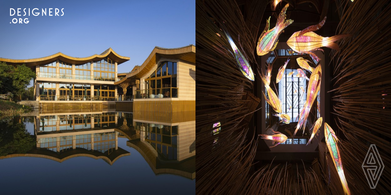 The project is located in a farmland with a beautiful environment in Guangdong Province. Surrounded by the water, the design combines the irregular column spacing scales that have been constructed to carry out the conception and creativity. It extracts inspiration from the traditional Hakka houses in rural China, adopting the undulating roof form to echo the water wave. In the interior, the fish-shaped decorations are used to intersperse the waterscape and try to complement each other.