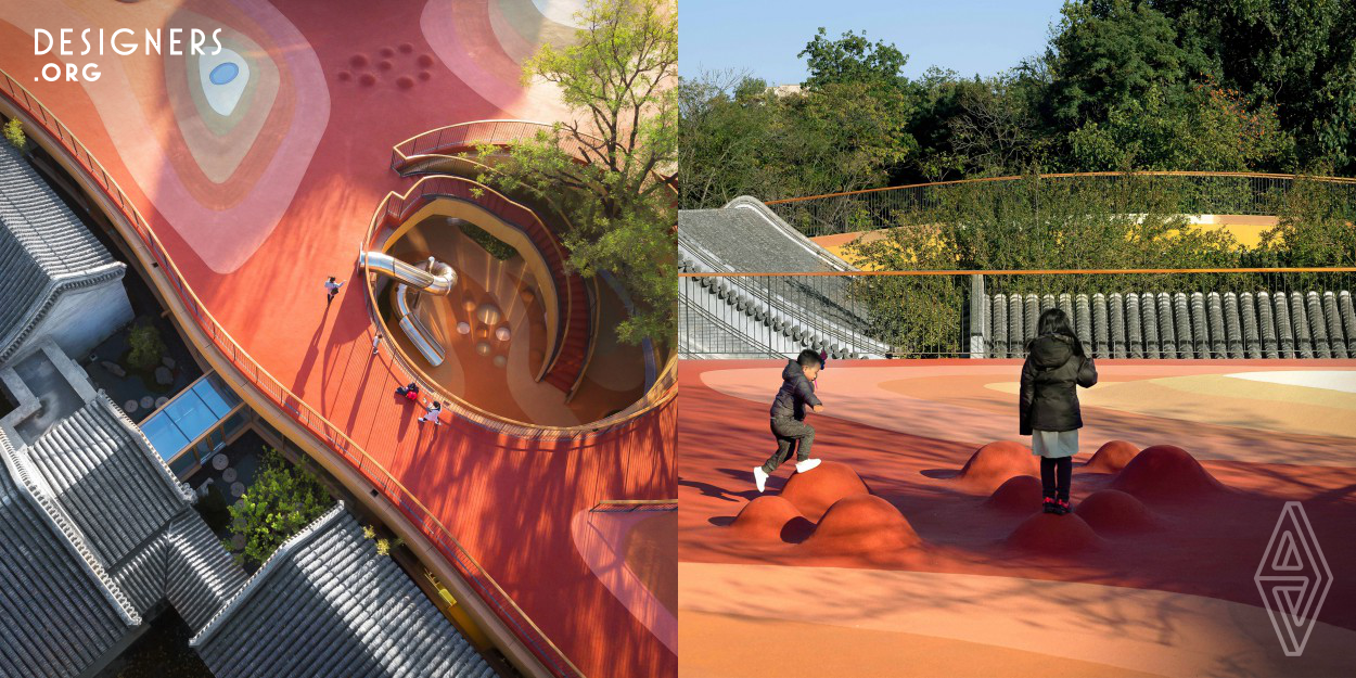 Utilization of the open rooftop space made it possible to enhance the kindergarten's edutainment needs without sacrificing the preservation of the historic courtyard buildings and trees. The rubberized playground surface material cloaks the entire roof in varying hues of earth tones and provides a safe and comfortable surface on which the children can run, jump, fall, laugh, crawl and climb. The rich colors were derived from the vibrant pallet of colors that wrap the eves of the ancient Chinese buildings, further referencing the connection between the old and new. 