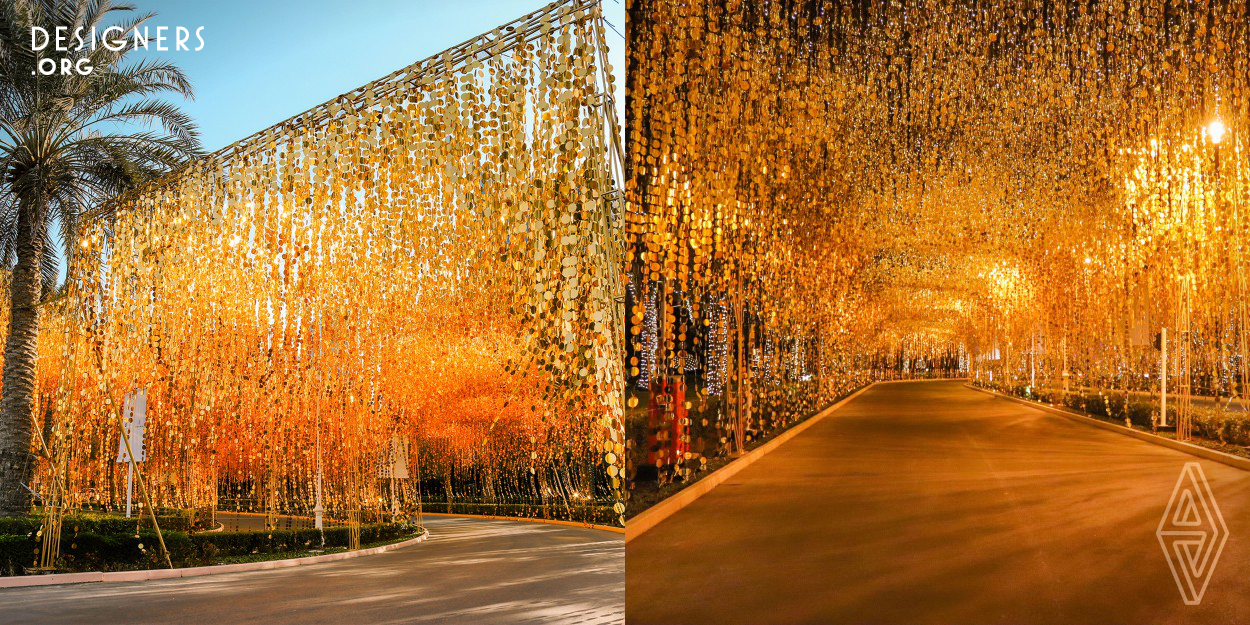 An ephemeral art installation inspired by the "Midas touch", composed by 1.000.000 golden sequins to attract good luck and fortune! To create a tunnel effect were used different size chains from 1 to 6 meters long that move with the wind, shine and create reflections in the surrounding area, depending on the incidence of light. Hidden in the middle of the golden dots, 2880 meters of golden led light curtains light up in the night involving the viewer by transforming their state of mind!