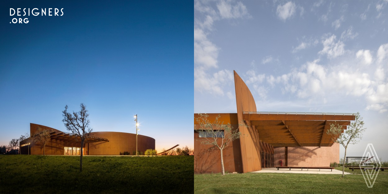 Forum Fondazione Bertarelli is a concert hall for 350 people surrounded only by nature on the slopes of Mount Amiata, in the Tuscan Maremma, where amplification takes place thanks to the shape generated by golden ratio and natural materials, in order to avoid it from being too rigid in that environment created by the light and wind. Replaces a plan which, in that very place, provided for a complex of nine residential buildings. Aesthetic values are not perceived as added, they are part of the building and radiate from it. From the sky it looks like an olive still attached to its nearest leaf.