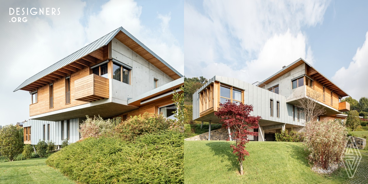 The harmonious integration into the surrounding landscape guided the formal and functional choices of this project, designed to accommodate the morphology and topography of the site, that takes quality and ecological commitment into high consideration. The two housing units, that share the common service areas on the ground floor, propose different ways of living, as they are developed differently to the local countryside. Materials and the dry-type construction, are in line with the eco-sustainable design to respond to the desire to live in a house in the green without wasting natural space.