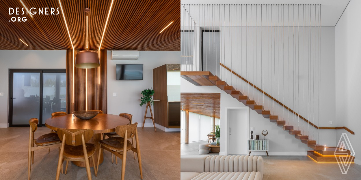 The Casa da Varanda's design intended to be an integrated space to promote family’s meetings, to receive friends, to cook while stay together and have fun. The design specify natural materials such as concrete, wood slats, brick, and a rustic porcelain tile floor with a stone effect. The lighting in LED bars was designed to be positioned between the wooden slats in the ceiling. Quartz countertop supports a natural wood top table in its extension . Wooden furniture, leather and linen fabric are materials used to get the environment more cozy. 