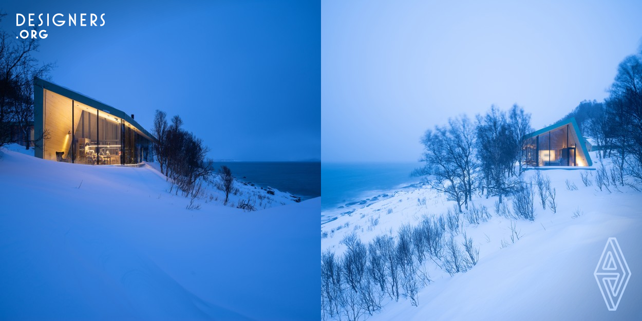 The Aurora Lodge is delicately positioned on a natural plateau, sloping artfully down to the sea and rocky beachfront, with undisturbed views over the Arctic Ocean’s Norwegian Sea and across remote islands in the distance. The property is typified by a gentle creek that routes along the pathway to the Lodge, and under it, between the annex and the sauna. Aurora Lodge is situated in the Lyngen Alps, Norway. The lodge is designed to ensure undisturbed connection with the surrounding nature, combined with complete privacy and follows the slope of the existing terrain.