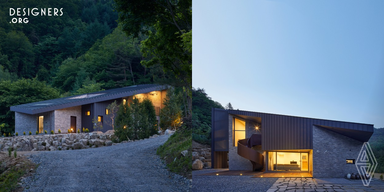 The project is located on a gentle slope of a mountainous topography in Wonju city, South Korea. Main design concept for this house is to compose a sloped surface that doubles as a roof and a facade. The roof is not only an apparatus that gives strong visual impact to residents and visitors, but also a metaphor of the slope of the Kam-Ak mountain at the site. Also the sculpted out terrace on the roof, which is facing toward the eastern mountain, provides spectacular views throughout an year with varying sceneries.