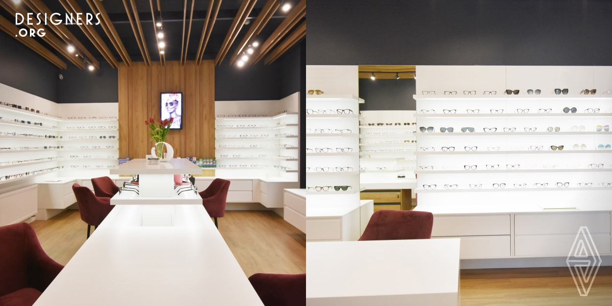 Design of an optical store of a higher standard than the investor's existing stores. Artistic concept based on a linear composition. Horizontal shelves that are interrupted by vertical elements dominate. A space built with contrasts: colors, textures, forms. Display, storage, customer consultation area and sales area are included. An interior without internal divisions visually enlarges the space. Low form in the center, tall forms by the walls. The detail gives individuality to the designed space. 