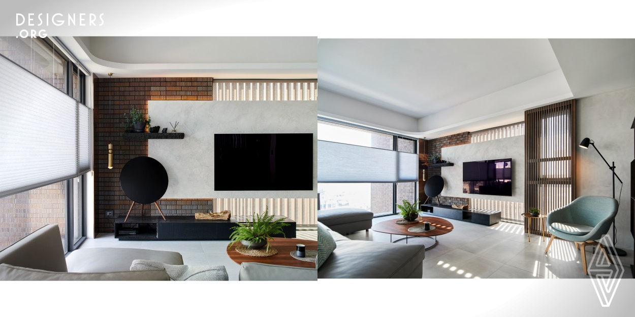 This project is located in a high and rise building in a downtown area of Taiwan (R.O.C). The indoor space is surrounded by wide and spread French windows having an excellent view. Extended a part of the structure surface of the building to indoor to enhance the weight of the main TV wall. With the two inch hanging tiles and solid wood, grilles combine outdoor and indoor space, to achieve a balance between the two. Using a hovering TV wall and the lines of tiles and grilles finds appropriate visual proportions.