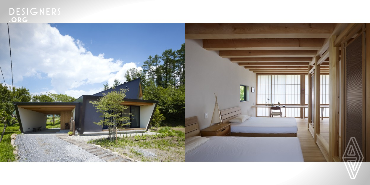 Situated in foothills of Mt. Yatsugatake, this vacation house gently incorporates the natural environment around it. The fan-shaped design opening to the south means plenty of sun streams in during the cold winters: no matter the time of day there's always a place to bask in the sun. In contrast, strong summer sunshine is blocked by a roof and side walls that protrude beyond the facade, providing shade. Windows in the north and south exterior walls bring cool breezes into the house. The result of design strategies is a structure that is simple yet filled with a rich diversity of scene.