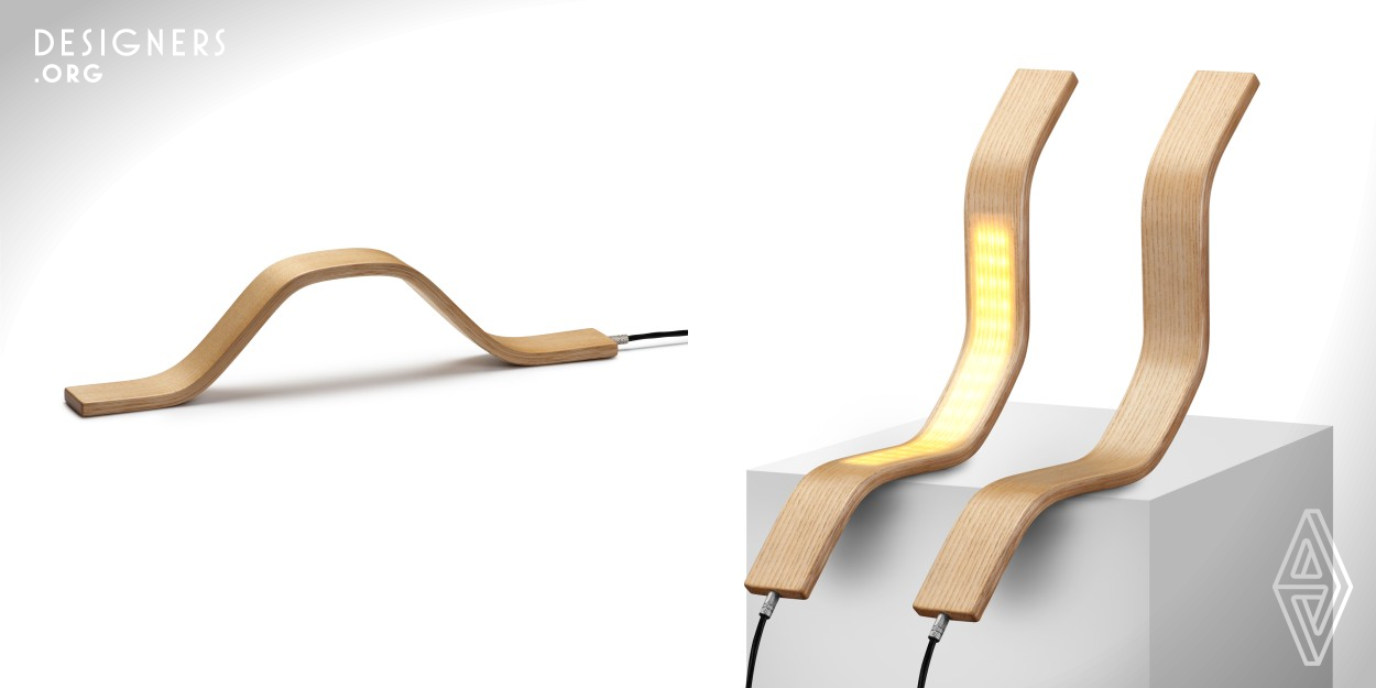 A lamp made of bent natural ash wood. Its shape seems to be a simple wooden bow, but it conceals an LED light rail that only becomes visible when the integrated touch switch is pressed. Thanks to an equally invisible magnet, it adheres beautifully to any iron surface or dedicated support, but can also, according to the modular principle, be transformed into a multi-part floor or pendant luminaire.