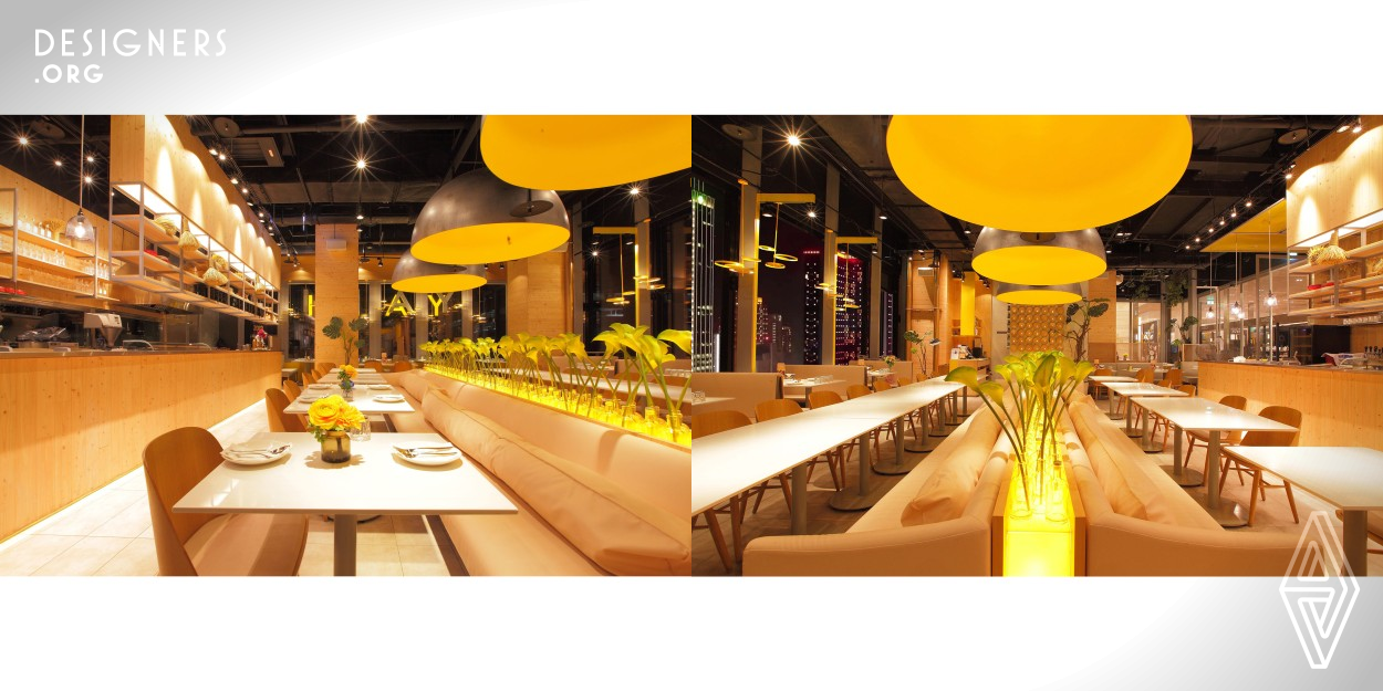 The whole project is mainly colored with ginger, which is following the core image of the brand. Besides, this space is decorated with stainless steel and light gray, like the contrast between the color science of extreme gray and yellow. Since the restaurant is mainly selling Asian fusion cuisine, the designer decorates the entrance with steamer-shaped lights. As for the dining area, the designer puts green plants into the glass bottles of sparkling drinks that are sold in the restaurant to convey a clear and unique brand impression.