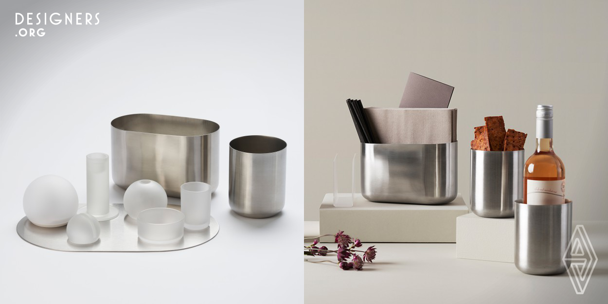Inspired by the nature of the polar circle, and designed for multi-usage. The steel containers have a removable compartment inside and fit into each other for a range of combinations. Use them as cutlery holders, for snacks, or as a flower vase. The steel can be chilled and used as wine cooler. The glass items are fit for candles and LED plugs in addition to food servings or accessories. Organise the items on the steel centrepiece or use the centrepiece individually as a serving plate. The sphere-shaped LED plug holder can be fitted with a suspension kit and hung from the ceiling or a wall. 