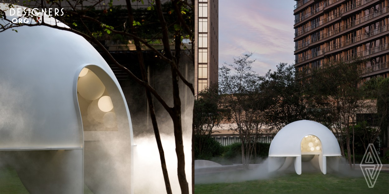 Dreamscape is a voluptuous sculptural form that appears to float above the K11 Musea Bohemian Garden. It regularly disperses mist, thus, from afar, it appears as an illuminated white shell emerges from a billowing cloud, tempting guests to engage in a relaxing urban misty moment. Up close, three arches are anchored onto six feet that touch the ground lightly, emphasizing an ephemeral shared experience. Once inside, the 250 illuminated bubble lamps are timed to evoke dreaming in a sleeping cloud.