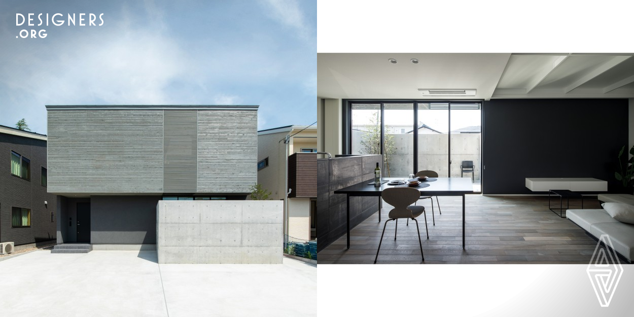 This house was planned in an old residential area. It is designed to change the uniform cityscape in cooperation with the old cityscape. The outer wall is made of wood painted in light gray. The weathered-colored houses match the streets of old houses. The floor plan of this house is characterized by a courtyard on the ground floor and a roof terrace on the second floor. The two gardens create a private space. People living in this house feel the nature outside while staying indoors. This house, where you can feel nature in your daily life, realizes a comfortable life. 