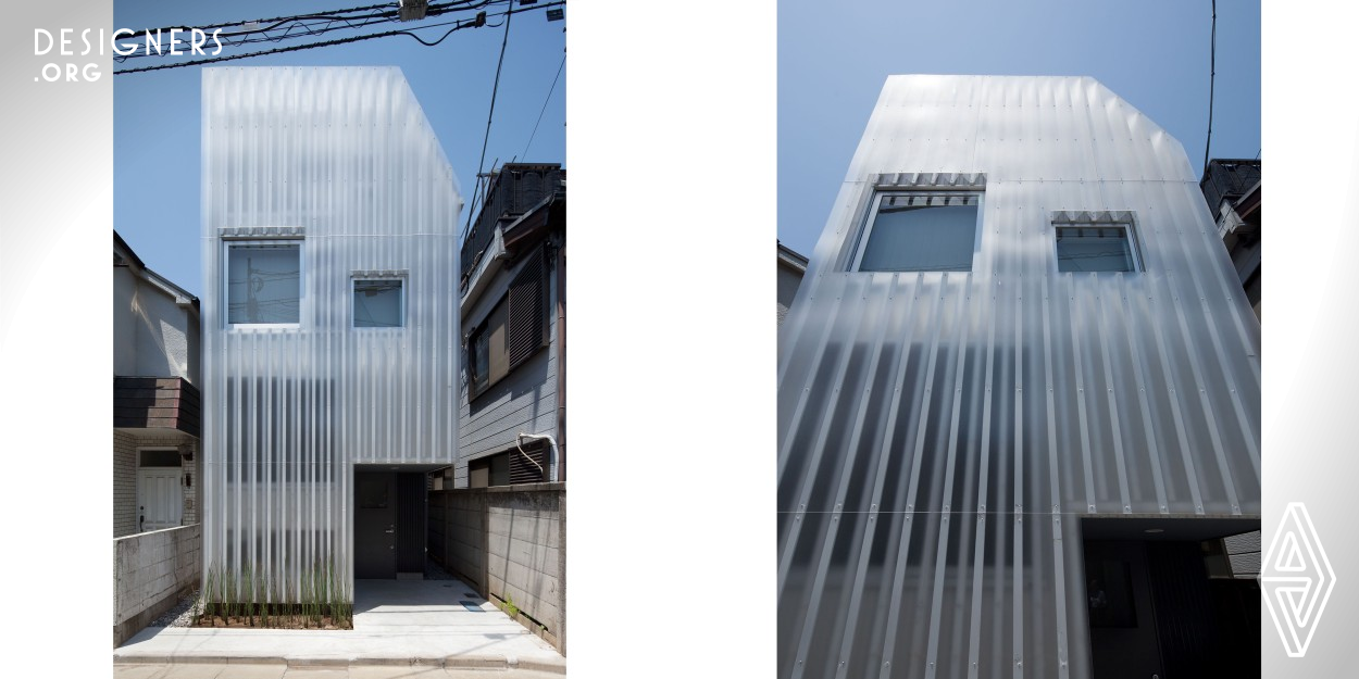 This building is a three-story wooden structure in a densely built up area of Tokyo. Although the site is small and the distance from the neighboring land is only about 1m, light and privacy were required. Inspired by the traditional Japanese shoji which softens the light, the designer have created a modern light filter that is resistant to wind and rain and can also be used outside. The translucent cladding on facade softens the light from outside and blurs the visibility of both passerby's and inhabitants. At night, the lighted facade become a large light to illuminate the streets.