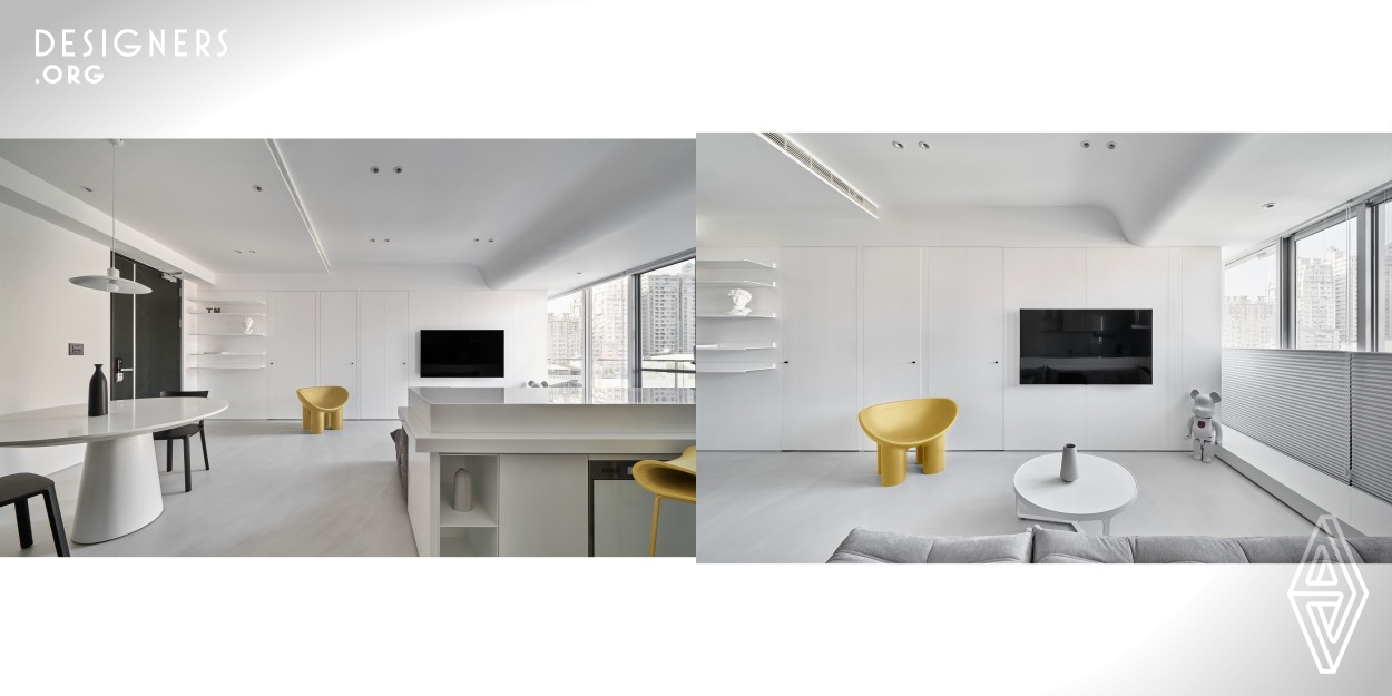 The interior of this design contains 75 percent white space. The use of different materials creates a simple but sophisticated design. Additionally, using gray floors and black furniture emphasizes the overall visual effect, as well as the purity and flawlessness of white. The unique curved ceiling design in the living room modifies the oppression caused by the rigid girder. White expresses the spatial structure more clearly, interweave a unique visual shape, and extend our perspective. White color purifies the indoor environment and shows pure beauty.