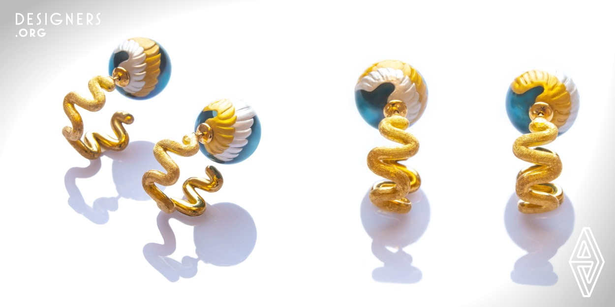 These earrings convey an image of the angelic power of blessing felt in the world. Angel wings are depicted with the use of Maki-e, Japanese traditional lacquer technique, on the South Sea pearl catches. The 18K yellow gold wavy hoops with hand engraved Italian traditional Florentine Finish represent the magical angelic energy. The hoops were created with responsibly sourced Valcambi Swiss Gold Products. This design can be worn two different ways, either by placing the wavy hoops at the top, or at the back.