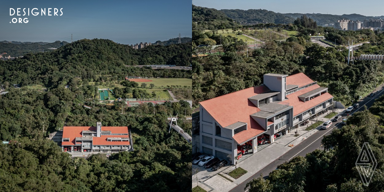 Fire station could be a very important landmark in a neighborhood and yet still blending into the environment. This project is located at Keelung, a mountainous and rainy city with more than 90 percentage hills. The concept is to adapt mountain house style at this area, which have taken into the main building elements to infect the landscape and climate. The sloping roof is a new layer of the mountain skin. The balconies and openings form special spaces in-between the landscape and the building and creates additional depth in the summer to avoid sunlight but still allows natural ventilation.