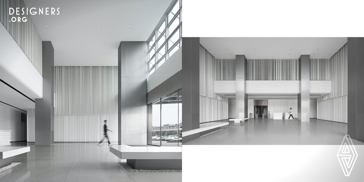 The project is a mixed-use building office lobby in Dongyu Logistics Park in Yiwu, Zhejiang, China. Inspiration is drawn from the bar code and container in the logistics industry. The original four isolated columns are adjusted and integrated into the whole structure. Various aisles are created. The alumina plates weaken the heaviness of the columns, making the space high-tech. Different textures of marble and aluminum metal overlap and collide to make the space more layered. This is how the designer built an efficient office, setting a new trend for logistics.