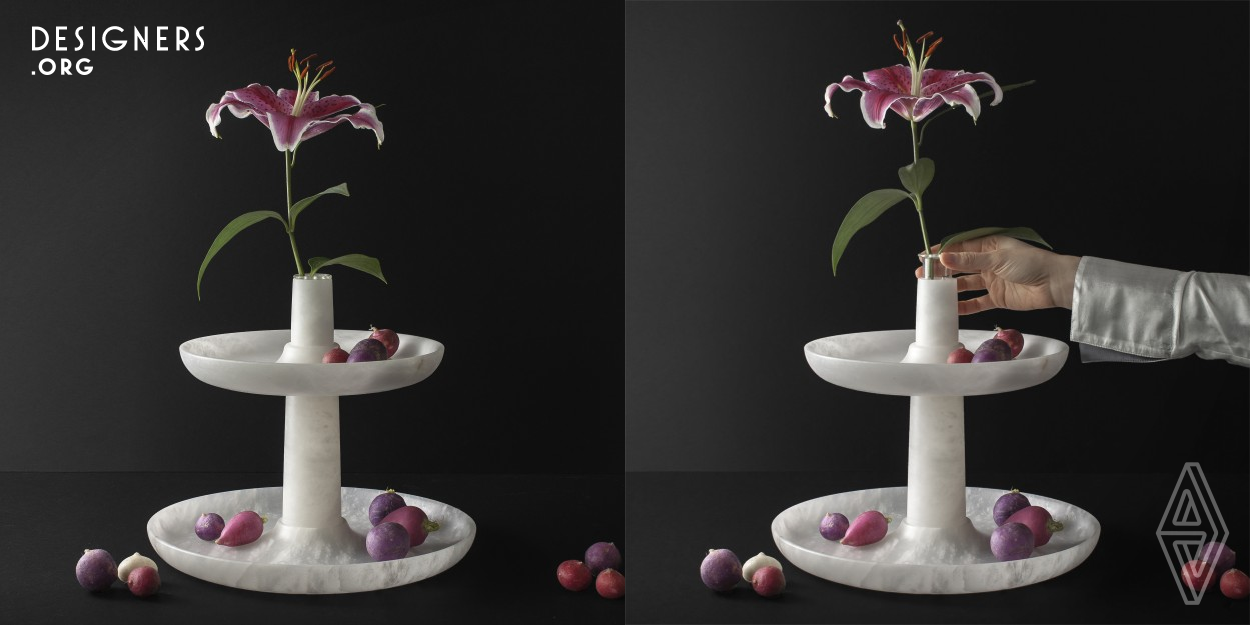 Flora is a vase and a stand. A handcrafted sculptural centerpiece that aims to help you stay present and focus on the natural elements that surround daily life promoting an intimate relationship with nature in the domestic environment. A way to elevate flowers and fruits to the level they deserve. Amazed by the beauty of nature while evolving in time Flora was designed as a tribute to the concept of metamorphosis of plants. Flowers and fruits are in essence the same thing, they are just at different stages of their lives. 