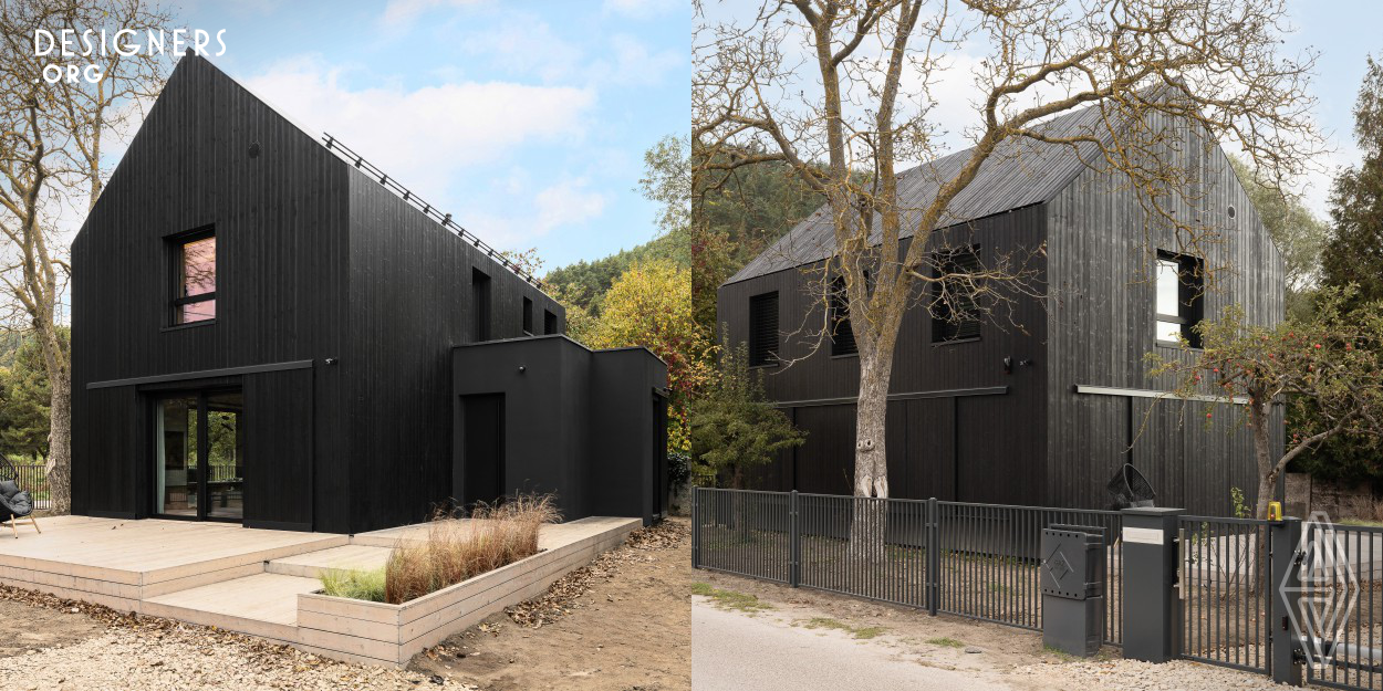 Realization of the reconstruction of a farm building from 1940, in a district of the city, which is a remnant of a former village. Beautiful location in a valley surrounded by forest and next to fish ponds. The reconstruction assumed a reference in the body and finish of the building's facade to the former barns. Attention to detail, respect for the history and tradition of the place, and the character of the buildings of the old village. The facade and roof were made of charred boards Scandinavian spruce and Siberian larch, and automatic shutters refer to the barn gates. 
