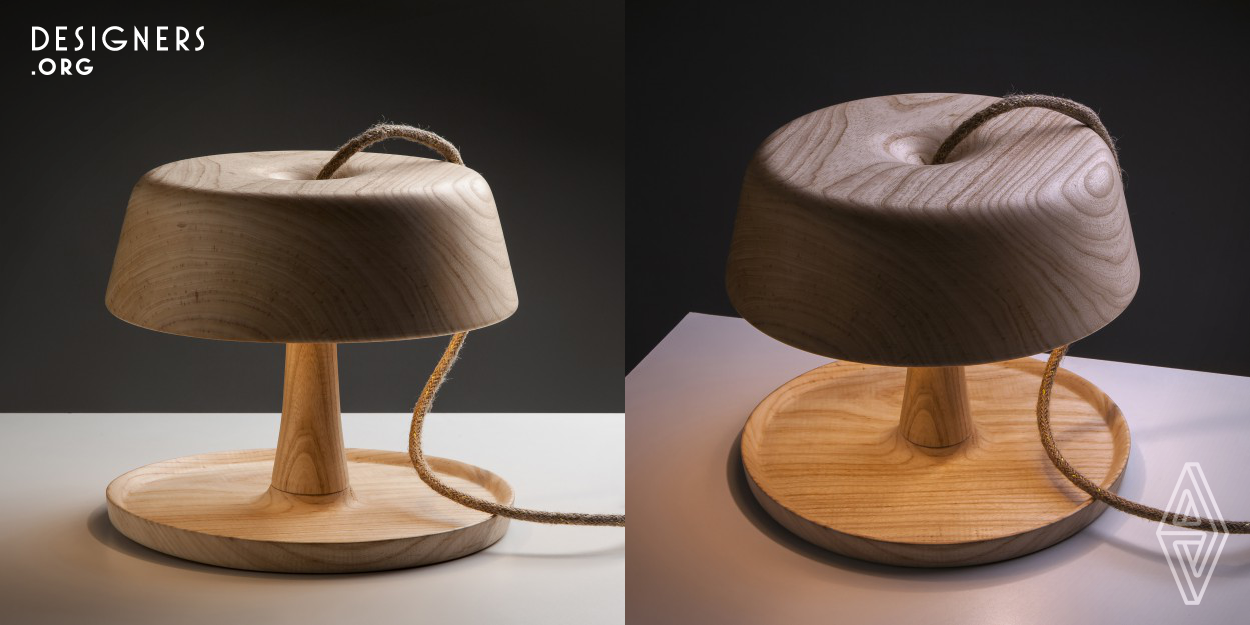 The Wood luminaire was designed in 2017 with the clear intention of being different from what was seen on the market then. It refers to and is inspired by the classic designs of the 60s. It is made entirely of solid wood and turned by hand, a material that transmits warmth and thanks to its nobility it has a distinguished quality and presentation. Design with simple and clean lines, where the cable that breaks with a paradigm stands out, not only because it comes out of the top of the product but also because it is an exclusive design cable with jute mesh and details of golden lurex threads.