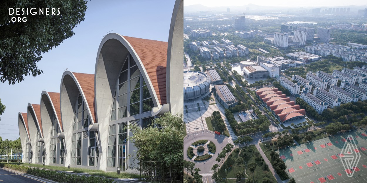 The Natatorium of Southeast University is located on the Jiulonghu Campus. The design uses continuous arches to eliminate the sense of alienation from the volume, like a flower, woven together in 7 repeating forms. Fluid water, moving people and static buildings, gray concrete and blue water, sunlight refracted by louvers, and shadows formed by geometry, all of which stimulate a strong sense of place. The structure is in line with the mechanical requirements, and the facade uses a large area of glazing, which forms an interaction between behaviors and sights of the people inside and outside.