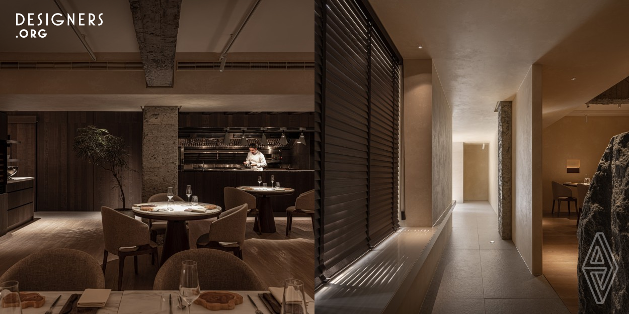 Ecru comes from the French word Ecru, describing the color of unbleached linen. Ecru Restaurant in Taipei's East District aims to offer a relaxed dining experience. The design uses a corridor at the entrance to shift from city hustle to tranquility, leading to an open area with a central open kitchen. This setup integrates cooking into the dining experience, engaging diners with sounds and aromas.