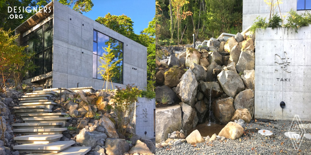 Taki is a landscape project for a site in Niseko, Japan. We wanted to create an ideal space while respecting the existing buildings and the natural environment. A staircase made of the same concrete slab as the exterior walls was designed to bring a sense of unity between the building and the garden. The artisanal masonry waterfall, created using natural spring water, has a strong design impact. Seasonal flowers are planted along the promenade, allowing visitors to fully enjoy the four seasons of Hokkaido. 