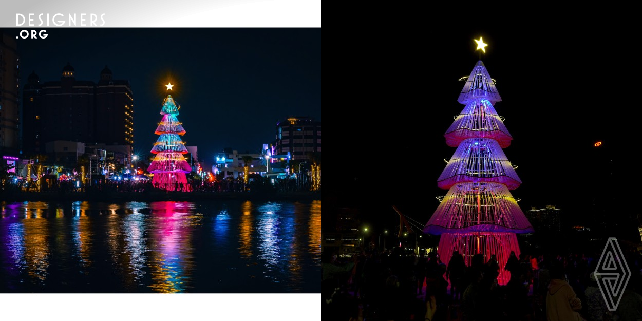 This is a lighting installation designed for Christmas. Utilizing wooden lattice, the installation reveals its internal structure, forming the shape of a tree. Different and changing colors of light are projected onto canvases at the bottom of each layer, creating a vibrant and diverse display. The installation is situated near an old canal, the brilliant array of colors makes the entire installation a visual focal point, infusing the entire harbor area with a lively festive atmosphere.