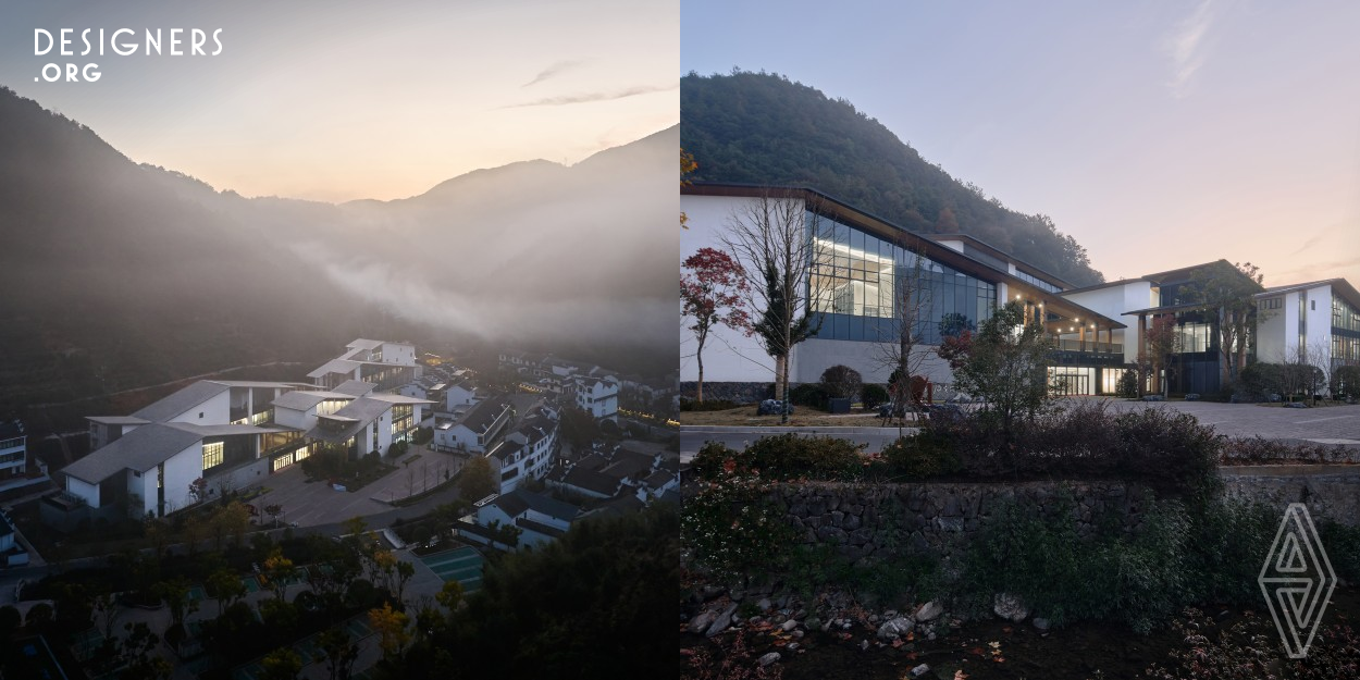 The project is located at the entrance of Yahuang Village, backed by mountains and facing water.  In order to place high-density building into irregular plots, and to fit the surrounding fragmented village texture and mountain. The design cuts the building into slender strips and arranges them irregularly. The top of the individual building is covered with a sloping roof, and the community shape simulates the layering of mountains. Numerous courtyards are formed between the long buildings, enriching the internal space and inheriting the traditional Chinese courtyard style residential houses.