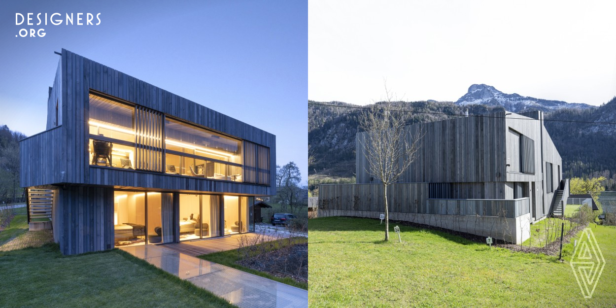 Set against the stunning scenery of Lake Mondsee, this architectural project embodies sustainability and technological progress. Constructed entirely from cross laminated timber (CLT), the house blends seamlessly into its surroundings. The integrated photovoltaic panels on the roof efficiently capture solar energy, while geothermal probes are responsible for heating. The automatic systems control the natural ventilation and heating. With its focus on environmentally friendly materials and energy-efficient mechanisms, this wooden house offers a modern yet harmonious refuge.