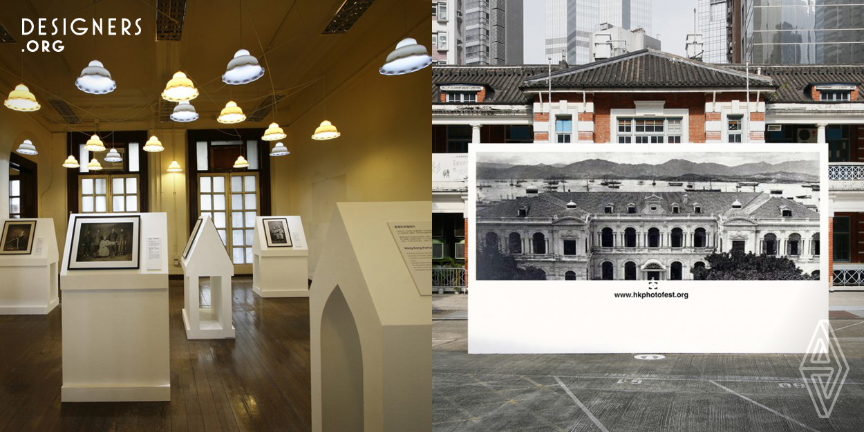 Flashlight indicator models were set to guide visitors to the entrance of the exhibition hall where a giant white camera model awaits. Standing in front of it, visitors can see the superimposing views of the black-and-white photo of early Hong Kong and the current exterior of the exhibition venue. Such setting implies that visitors can view the old Hong Kong through the giant camera and discover the history of Hong Kong photography through this exhibition. Indoor rotunda and house-shaped display stands were set to display historical photos as well as present an epitome of “Victoria City”.
