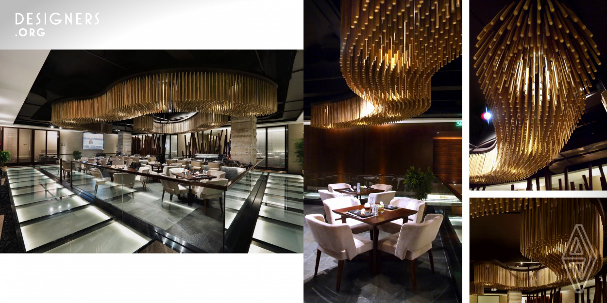A new theatrical dining experience cross-over traditional Japanese cuisine. This 650 sqm. restaurant contains a “thirty people open dining area” and “eleven VIP rooms” .The open dining area and stage like food bar were surrounded by an illuminated uplight glass walk path which made the centre stage as a statement. Natural bamboo ceiling feature with directional spot lights in a dark color open ceiling is another dramatic element to the main theme and helps drawing attention to the centre. VIP rooms were visually connected through a wood frame sliding door inserted with an engraved sandblasted 