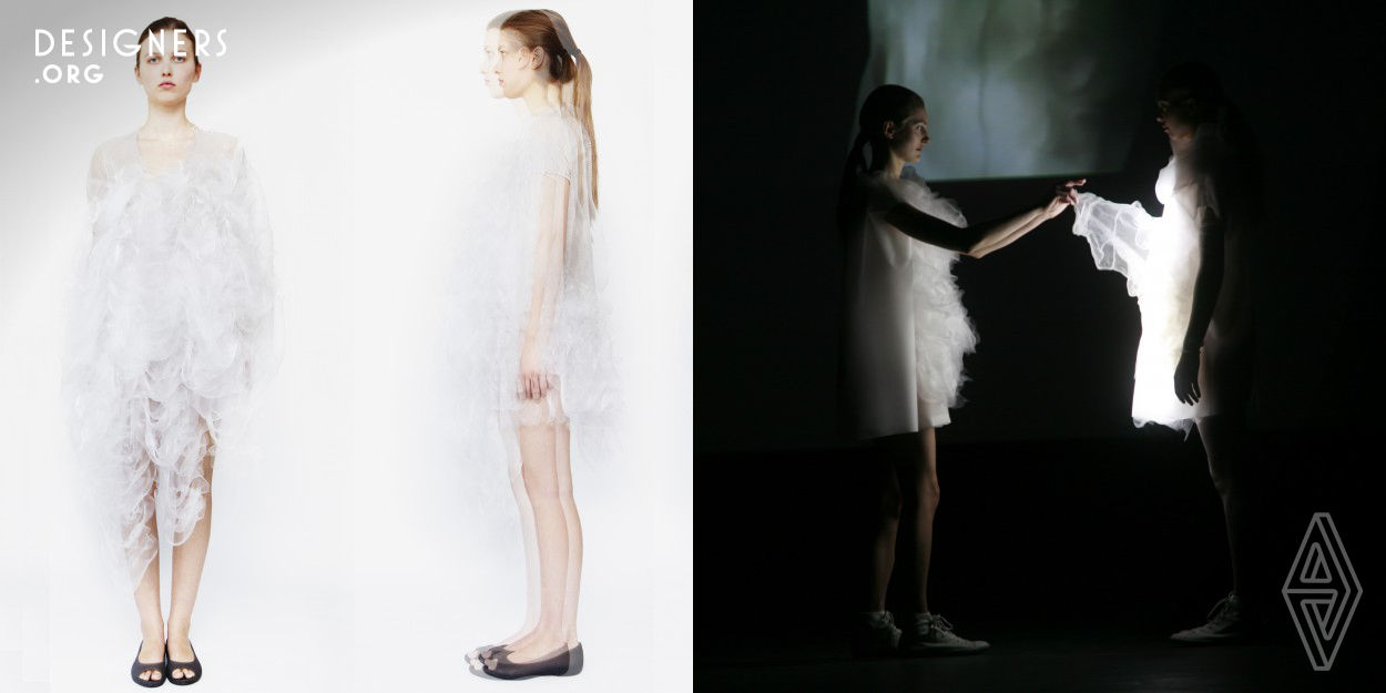 Playtime exists at the intersection of fashion design and interactive technologies. It references two key scenes of Tati’s film. Playtime explores the concept of transformation. In the context of a fashion show with sounds and lighting, the possibility for the viewer to photograph or shoot the dresses on video is rendered difficult: they will appear blurry in the recorded image. The first dress will appear blurry and the second dress will react to the flash of the camera, itself becoming a light source when a photo is taken.