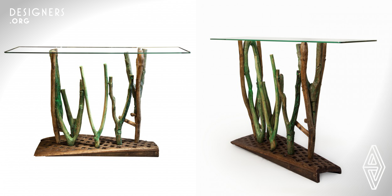Qadem Hooks is an art piece with a console function inspired by nature. It is composed of different painted green old hooks, which were used together with the Qadem (an old wooden mule's saddle back) for transporting wheat from one village to another.The hooks are attached to an old Wheat Thresher Board,as a base and finished with a glass panel on top. 
