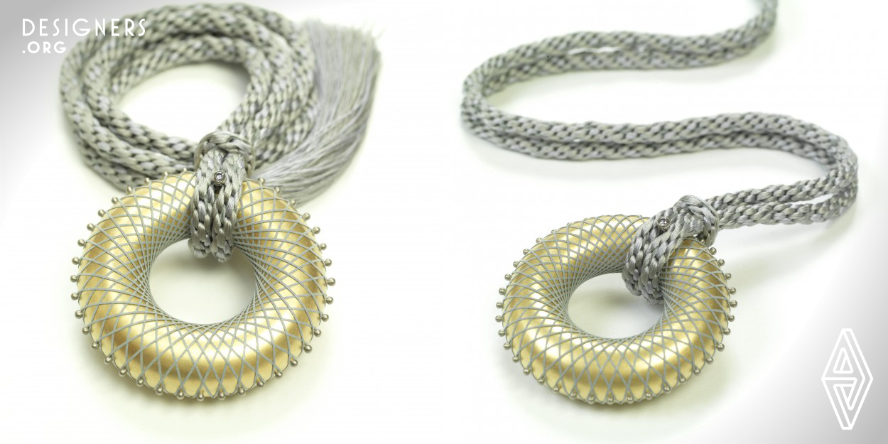 The design is inspired by the Neo-Platonic philosophy of macrocosm and microcosm, seeing the same patterns reproduced throughout all levels of the cosmos. Referencing the golden ratio and fibonacci sequence, the necklace features a mathematical design that mimics the phyllotaxis patterns observed in nature, as seen in sunflowers, daisies, and various other plants. The golden torus represents the Universe, enveloped in the fabric of space-time. "I Am Hydrogen" simultaneously represents a model of "The Universal Constant of Design" and a model of the Universe itself.