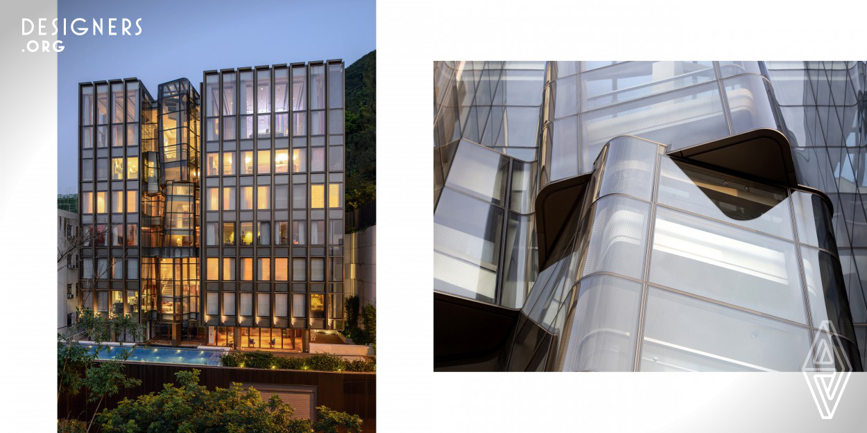 Located at a hillside on the Hong Kong Island, this nine-storey private residence is unique to the history and context of Hong Kong.   The design is inspired by a barren rock and a waterfall. The barren rock is portrayed by the uniformed lines and 1.5-metre modules on the façade, while the waterfall is reflected by the sculptural staircase. To realise the waterfall idea, the design team transformed the water into three stacking ice cubes and came up with the sculptural staircase.  The design also caters for the flexibility in possible future conversion into typical apartment units.