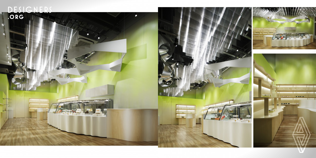 A store selling dairy products and belonging to a company which runs its own dairy farm. The space is composed of a luminous body evoking the imagery associated with milk, an important merit and key ingredient of their products, a color gradation suggestive of green forests, dynamic modeled aluminum objects diversifying one’s experience of the space’s depth and expanse, and fixtures with organic curves expressing vitality. The space sends a perspicuous image as a store seeking to make high quality products from dairy farm milk, which is at the base of all their products.